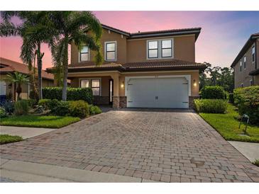 Two-story house with brick paver driveway and landscaping at 1048 Bradberry Dr, Nokomis, FL 34275