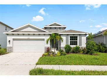 Charming one-story house with gray exterior and stone accents at 12665 Promenade Estates Blvd, Sarasota, FL 34238