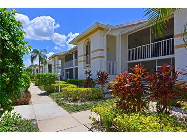 Condo building with lush landscaping and walkways at 6904 Drewrys Blf # 803, Bradenton, FL 34203