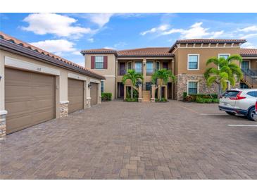 Two-story building with attached garages and palm trees at 12710 Sorrento Way # 101, Bradenton, FL 34211