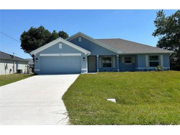 Charming one-story home with a well-manicured lawn and a two-car garage, perfect curb appeal at 4865 Manila Ave, North Port, FL 34288