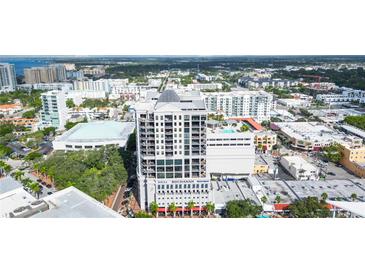 Aerial view of Insula Buchanan with city views, showing balconies, rooftop pool, and the building's design at 50 Central Ave # 17Phb, Sarasota, FL 34236