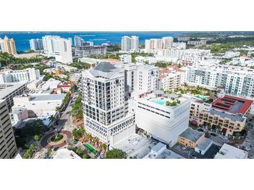 Stunning aerial view of a high-rise condo building with a rooftop pool overlooking the city and ocean at 50 Central Ave # 17Phb, Sarasota, FL 34236