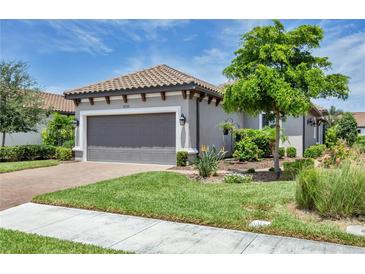 Single-story home with gray garage door and landscaped yard at 5732 Puccini St, Nokomis, FL 34275