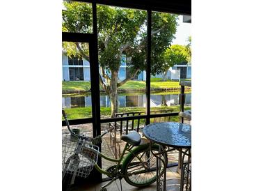 Enclosed patio with canal view, table, chairs and bicycle at 6033 34Th W St # 1, Bradenton, FL 34210