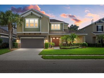 Two-story home with a two-car garage and landscaping at 4618 Arbor Gate Dr, Bradenton, FL 34203