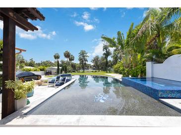 Resort style pool and spa with lake view at 11213 Riverview Dr, Riverview, FL 33578