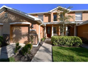 Two-story townhome with attached garage and landscaping at 11464 52Nd E Ct, Parrish, FL 34219