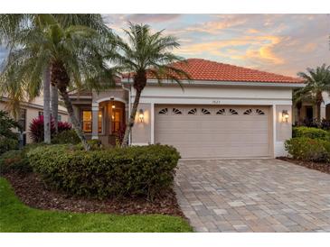 Charming single-Gathering home with a red-tile roof, well-kept landscaping, and a paved driveway at 7623 Birds Eye Ter, Bradenton, FL 34203