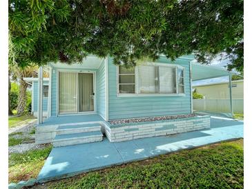 Light blue single-wide manufactured home with carport at 1806 Brook Field Ter, Sarasota, FL 34234