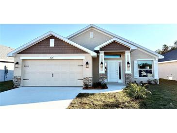 Two-story home with a neutral color palette and landscaped yard at 2624 Averland Loop, North Port, FL 34287