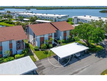 Aerial view of condo building with parking and waterfront at 4789 Independence Dr # 4789, Bradenton, FL 34210