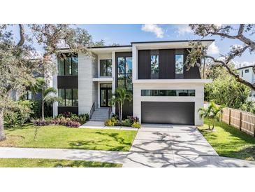 Modern two-story home with a two-car garage and landscaped yard at 214 S Renellie Dr, Tampa, FL 33609