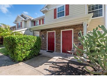 Two-story building with red doors and landscaping at 4850 51St W St # 2207, Bradenton, FL 34210