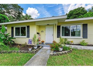 Charming yellow house with a landscaped yard and walkway at 1410 21St W St, Bradenton, FL 34205