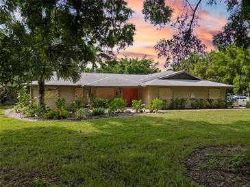 Charming ranch home nestled on a spacious lot with lush landscaping at 1525 17Th W St, Palmetto, FL 34221