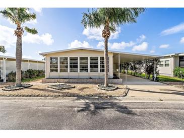 Charming single-wide manufactured home with carport and landscaping at 3410 Spanish Oak Ter, Sarasota, FL 34237