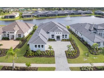 Aerial view of a luxury home with a large driveway and landscaping at 1217 Blue Shell Loop, Sarasota, FL 34240