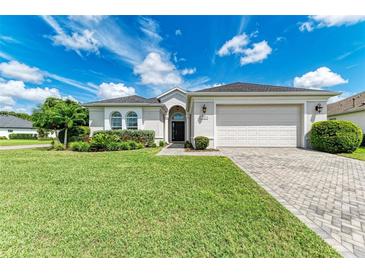 Single-story home with a two-car garage and well-manicured lawn at 12105 Goldenrod Ave, Bradenton, FL 34212
