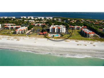 An aerial view of a condo complex located directly on a beautiful white sand beach at 1945 Gulf Of Mexico Dr # M2-310, Longboat Key, FL 34228