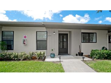 Inviting condo exterior with landscaping and walkway at 2704 60Th Avenue S Plz # 2704, Bradenton, FL 34207