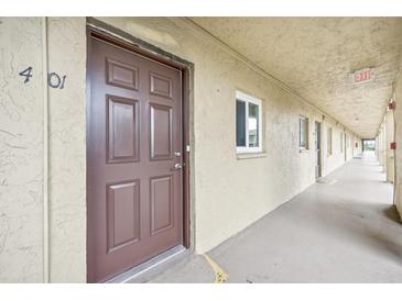 Apartment hallway with brown doors and light colored walls at 3777 Lake Bayshore Dr # H401, Bradenton, FL 34205