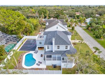 Stunning aerial view showcasing a home with a pool and basketball court at 3811 Bayside Cir, Bradenton, FL 34210