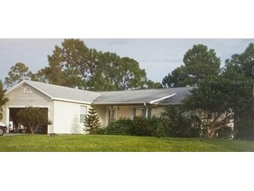 One-story house with attached garage and yard at 27373 Sandrala Dr, Punta Gorda, FL 33955