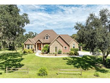 Two-story house with stone accents and a large yard at 7606 91St E St, Palmetto, FL 34221