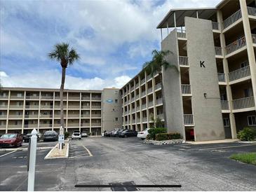 Exterior view of a multi-story residential building with parking in front at 3600 Lake Bayshore Drive Bld. K # 221, Bradenton, FL 34205