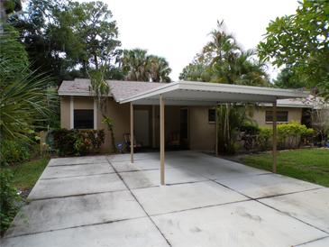 Tan house with carport and landscaped yard at 4973 Village Gardens Dr # 50, Sarasota, FL 34234