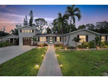 Two story home with landscaped yard, walkway, and updated exterior at 303 48Th W St, Bradenton, FL 34209