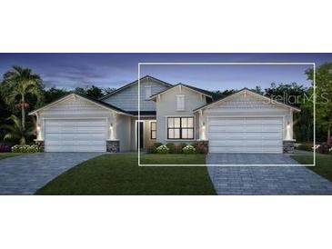 Two-story craftsman style home with a two-car garage at 18898 Dayspring Pl, Venice, FL 34293