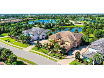 Luxury home with lake views in a gated community at 7546 Divot Loop, Lakewood Ranch, FL 34202