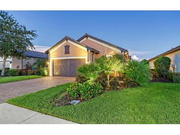 Attractive single-story home with landscaping and two-car garage at 8744 Bellussi Dr, Sarasota, FL 34238