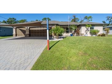 Two-story home with a two-car garage and well-manicured lawn at 4457 Maywood Ln, North Port, FL 34286