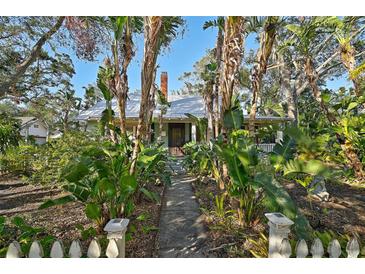 Charming house with lush tropical landscaping and a brick pathway at 1663 4Th St, Sarasota, FL 34236