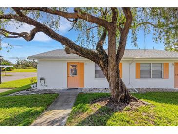 Cute bungalow with orange trim and a large shade tree at 1902 Andover St # 213, Sun City Center, FL 33573