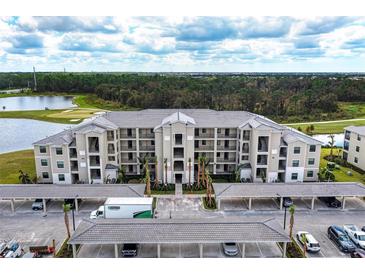 Modern apartment building with covered parking and landscaping at 18114 Gawthrop Dr # 403, Bradenton, FL 34211
