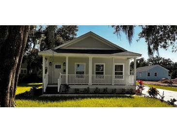 Craftsman style home with front porch and well manicured lawn at 710 N Thomas St, Plant City, FL 33563