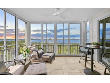 Comfortable lanai featuring tile flooring, ceiling fan, and panoramic views of the bay at 236 Hidden Bay Dr # 301, Osprey, FL 34229