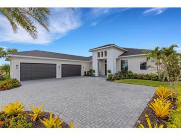 Luxury home with three-car garage and landscaped yard at 9004 Artisan Way, Sarasota, FL 34240