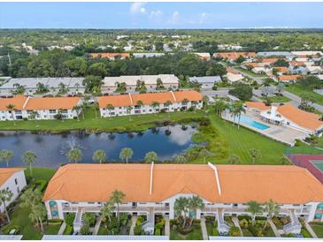 Beautiful aerial view of the community featuring a pool, pond, and lush landscaping, perfect for serene living at 4224 Madeira Ct # 3309, Sarasota, FL 34233