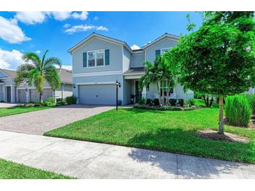 Two-story house with gray siding and a landscaped yard at 3360 Chestertown Loop, Bradenton, FL 34211