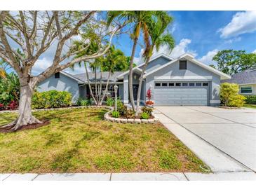 Charming single-story home featuring a well-manicured lawn, lush landscaping, and a two-car garage at 5306 19Th W Ave, Bradenton, FL 34209