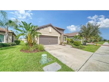 Single-story home with attached garage and nicely landscaped front yard at 220 Capriana Ct, Nokomis, FL 34275