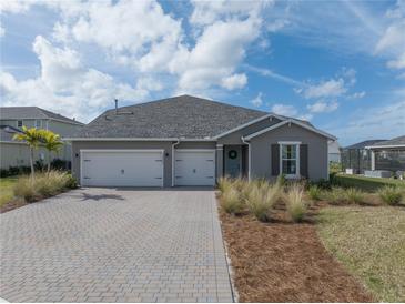 Two-car garage and attractive landscaping at 16208 Foxtail Ct, Punta Gorda, FL 33982