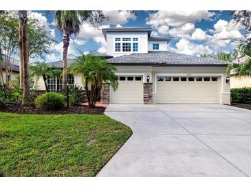 Two-story house with two-car garage and landscaping at 13814 Nighthawk Ter, Lakewood Ranch, FL 34202