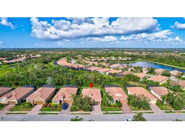 Aerial view of a single-Gathering home in a residential community with a lake at 9019 Heritage Sound Dr, Bradenton, FL 34212