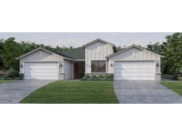 Two-car garage and farmhouse-style home at 18860 Dayspring Pl, Venice, FL 34293